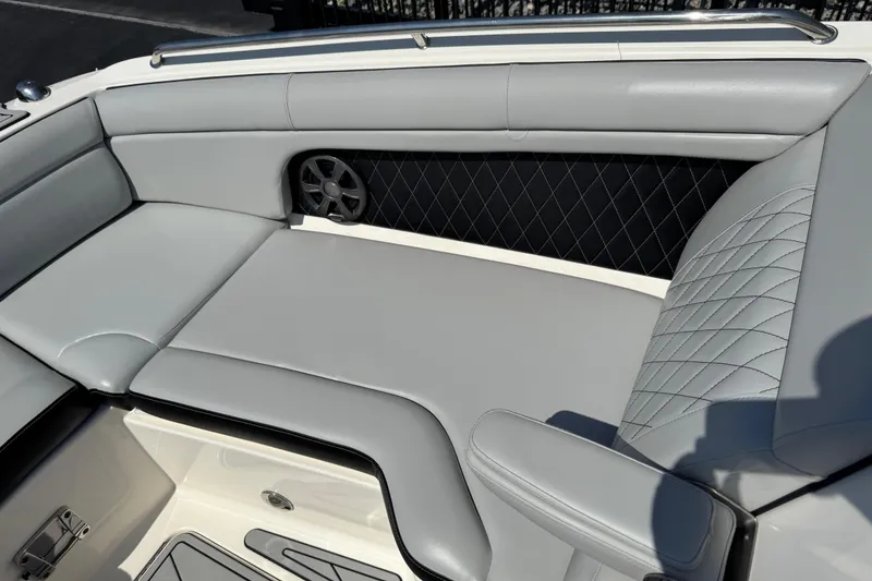Slide: The Image of 2019 Sea Ray SDX 270 Outboard boat interior with gray cushioned seating and speaker. - 29