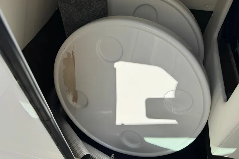 Slide: The Image of Storage compartment in 2019 Sea Ray SDX 270 Outboard boat with round white covers. - 31