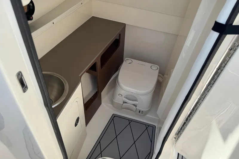 Slide: The Image of 2019 Sea Ray SDX 270 Outboard boat interior with compact bathroom and sink. - 33