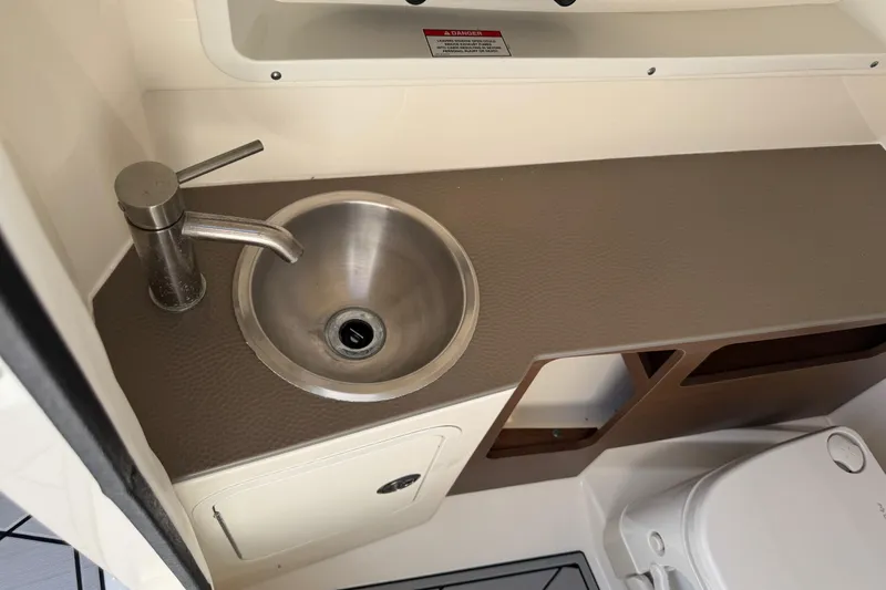 Slide: The Image of 2019 Sea Ray SDX 270 Outboard boat interior with sink and storage. - 34