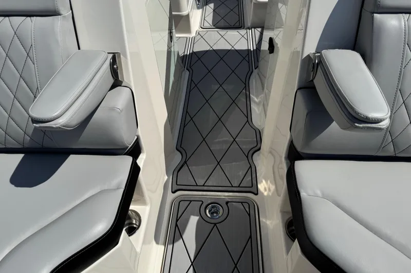Slide: The Image of 2019 Sea Ray SDX 270 Outboard interior with gray seating and diamond-patterned flooring. - 36