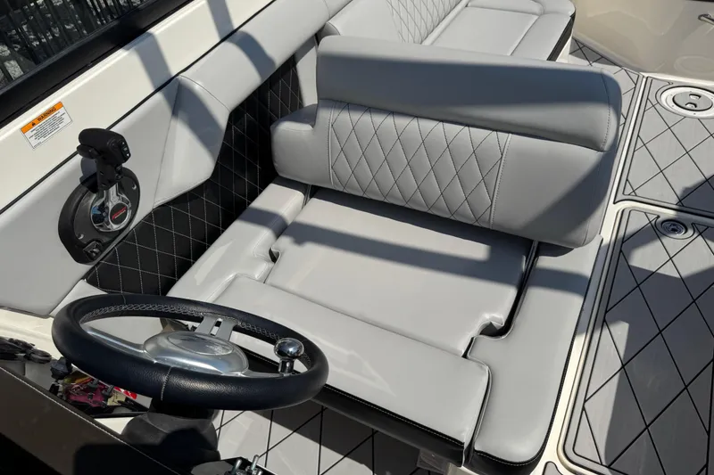 Slide: The Image of 2019 Sea Ray SDX 270 Outboard interior with gray seating and steering wheel. - 39