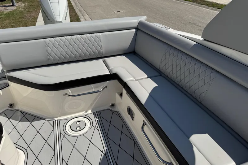 Slide: The Image of 2019 Sea Ray SDX 270 Outboard boat interior with gray cushioned seating and diamond stitching. - 41