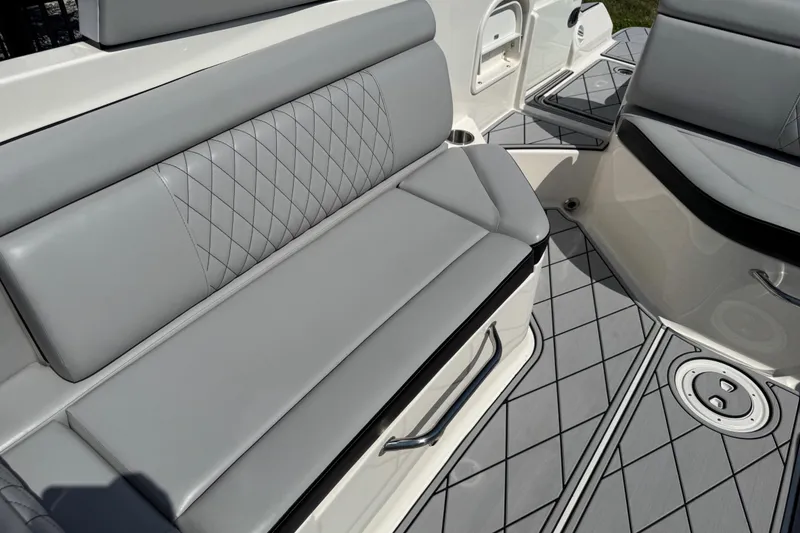 Slide: The Image of 2019 Sea Ray SDX 270 Outboard interior with gray seating and diamond-patterned flooring. - 42