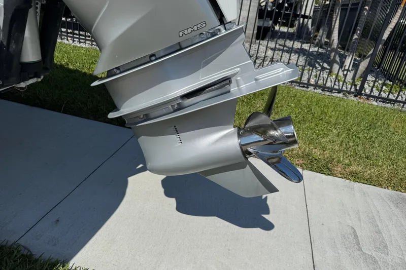Slide: The Image of 2019 Sea Ray SDX 270 Outboard motor and propeller on concrete and grass background. - 5