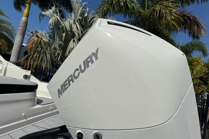 Slide: The Image of 2019 Sea Ray SDX 270 Outboard with Mercury engine, surrounded by palm trees. - 6