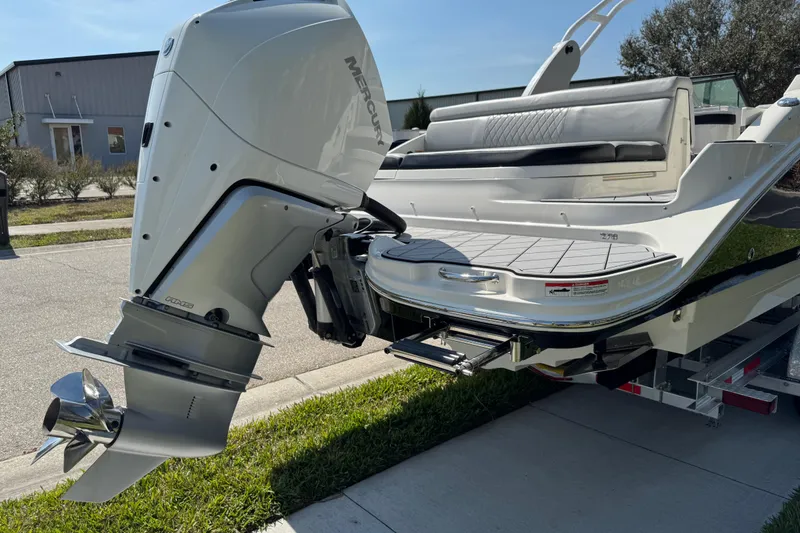Slide: The Image of 2019 Sea Ray SDX 270 Outboard boat with Mercury engine, parked on a trailer. - 9