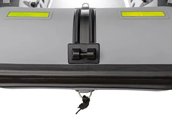 Slide: The Image of 2023 West Marine MH400 inflatable boat with yellow accents and secure tie-down. - 2