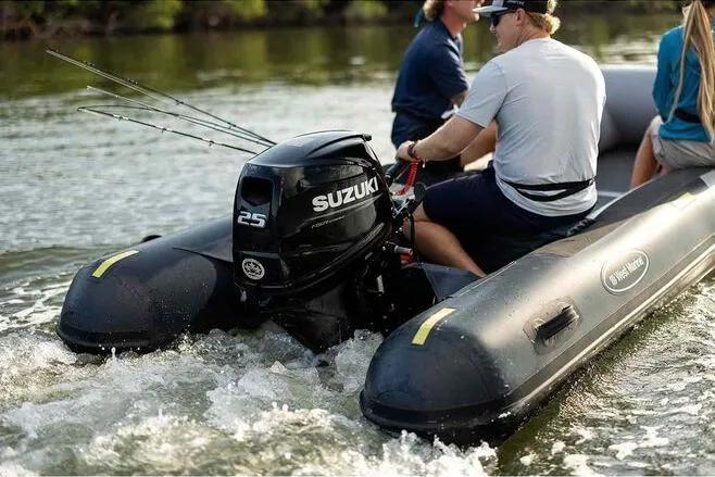 Slide: The Image of 2023 West Marine MH400 inflatable boat with Suzuki 25 outboard motor on a lake. - 5