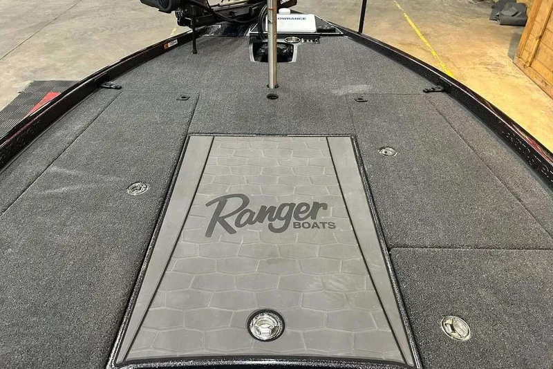 Slide: The Image of 2014 Ranger Z521R Cup-Equipped boat deck with logo, featuring carpeted surface. - 12