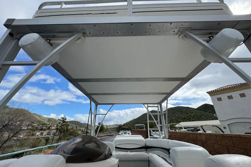 Slide: The Image of 2006 Bennington 2875RLTD I/O boat with scenic mountain backdrop and clear sky. - 10