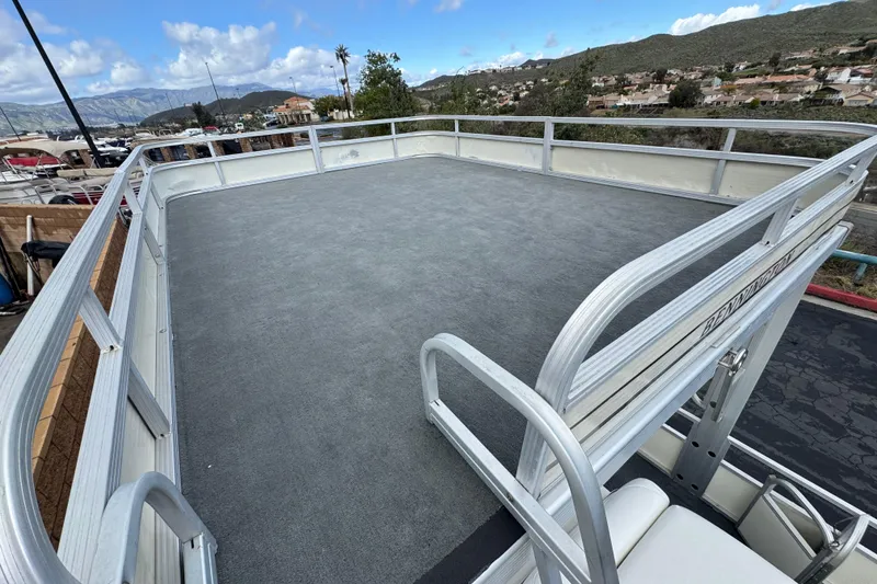 Slide: The Image of 2006 Bennington 2875RLTD I/O boat with spacious upper deck, docked at marina. - 13