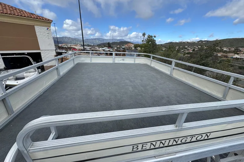 Slide: The Image of 2006 Bennington 2875RLTD I/O pontoon boat deck with scenic background. - 14