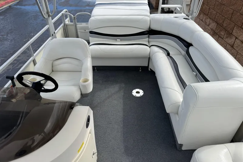 Slide: The Image of 2006 Bennington 2875RLTD I/O boat interior with white seating and steering wheel. - 24