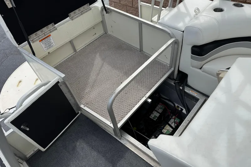 Slide: The Image of 2006 Bennington 2875RLTD I/O boat interior with open storage compartment and seating. - 26