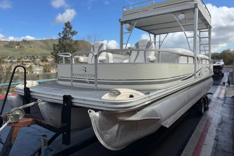 Slide: The Image of 2006 Bennington 2875RLTD I/O pontoon boat on trailer, scenic background. - 3