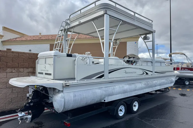 Slide: The Image of 2006 Bennington 2875RLTD I/O pontoon boat on trailer, parked outdoors. - 6