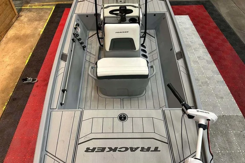 Slide: The Image of 2026 Tracker Bass Tracker Classic CC boat interior with seating and fishing rod holders. - 12