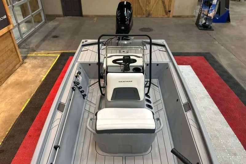 Slide: The Image of 2026 Tracker Bass Tracker Classic CC boat interior with steering console and seating. - 14
