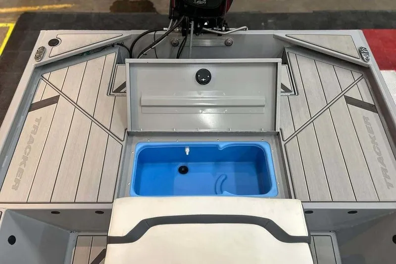 Slide: The Image of 2026 Tracker Bass Tracker Classic CC boat interior with storage compartment and blue livewell. - 15