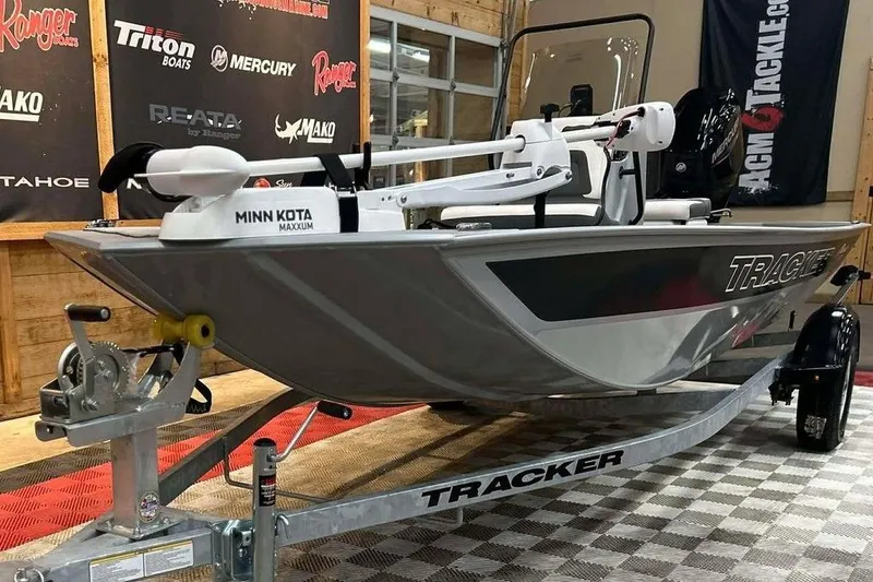 Slide: The Image of 2026 Tracker Bass Tracker Classic CC boat on trailer, featuring Minn Kota Maxxum motor. - 16