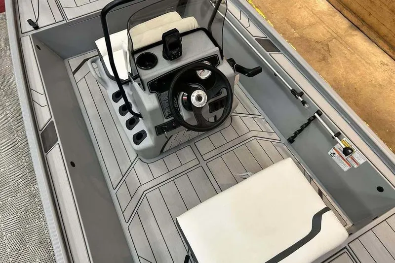 Slide: The Image of 2026 Tracker Bass Tracker Classic CC boat interior with steering console and seating. - 17