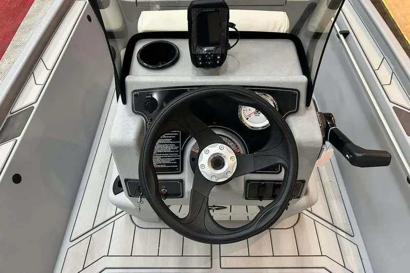 Slide: The Image of 2026 Tracker Bass Tracker Classic CC boat console with steering wheel and navigation equipment. - 4