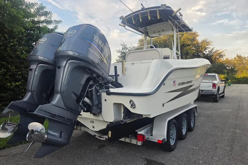 The Image of 2006 Hydra-Sports Vector 2500 CC boat with dual Yamaha engines on a trailer. - 0