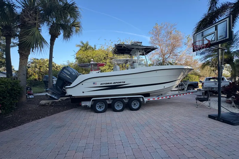 Slide: The Image of 2006 Hydra-Sports Vector 2500 CC boat on trailer, parked in a driveway with palm trees. - 10