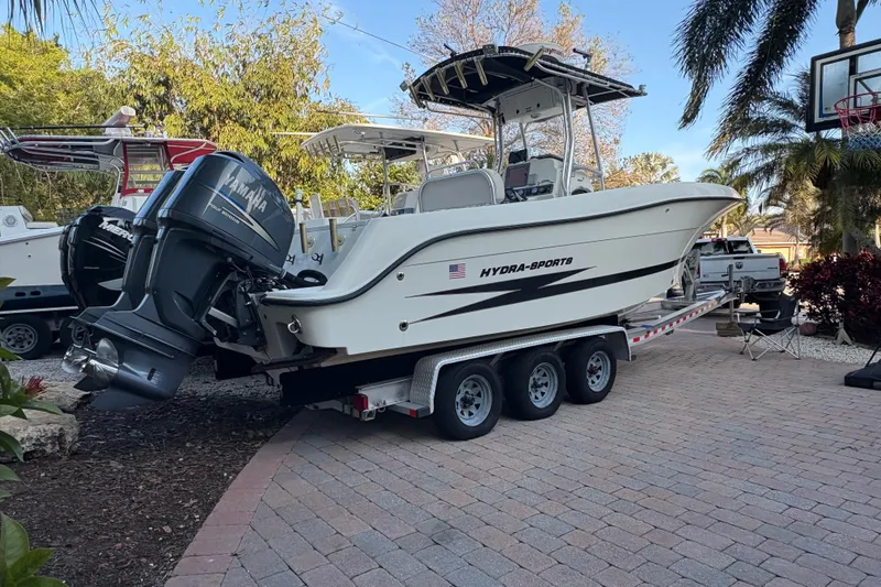 Slide: The Image of 2006 Hydra-Sports Vector 2500 CC boat on trailer, parked in a driveway. - 11
