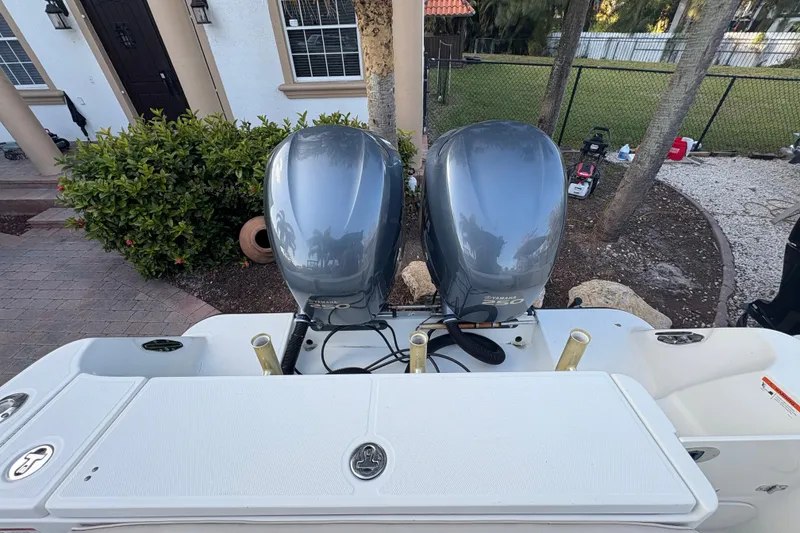 Slide: The Image of 2006 Hydra-Sports Vector 2500 CC with dual outboard motors in a residential driveway. - 9