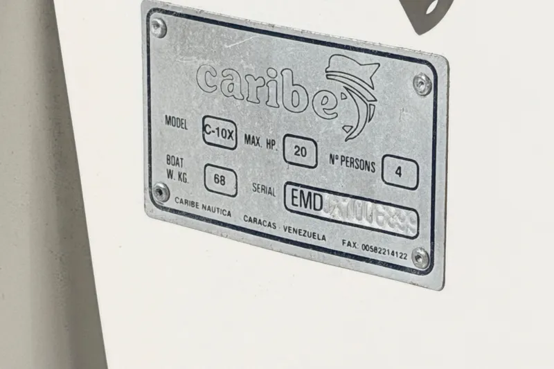 Slide: The Image of Metallic label on a 1999 Caribe C10X boat, showing specifications and serial number. - 4