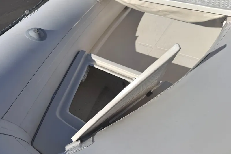 Slide: The Image of Open storage compartment on a 1999 Caribe C10X inflatable boat. - 5