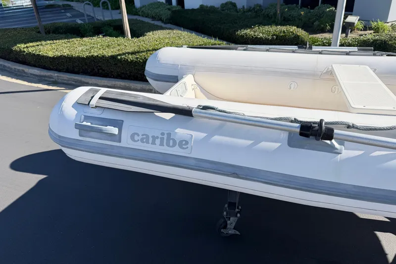 Slide: The Image of Inflatable Caribe C10X boat from 1999 on pavement, with oar attached. - 6