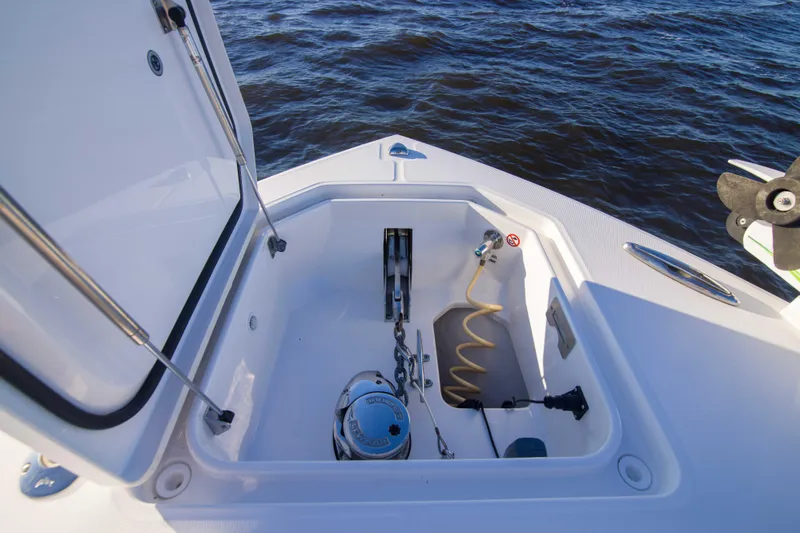 Slide: The Image of 2016 Regulator 41 boat anchor locker with equipment, open hatch, and ocean background. - 11