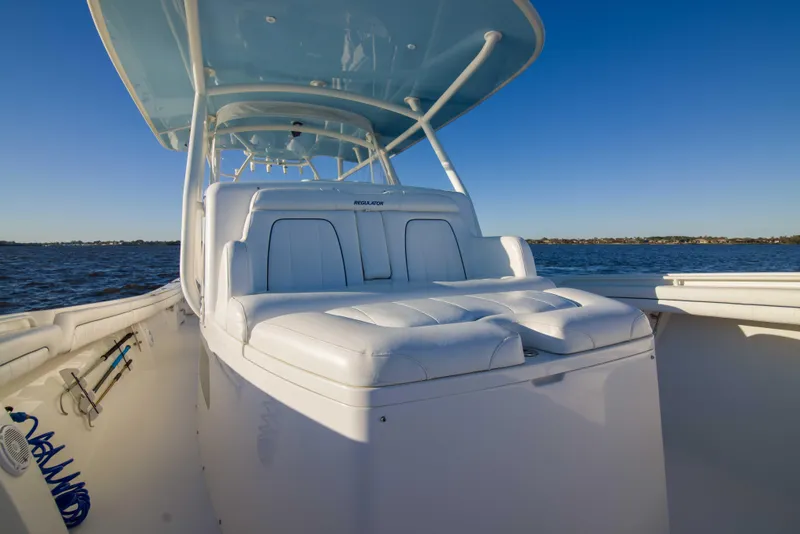 Slide: The Image of 2016 Regulator 41 boat with white seating, cruising on calm waters under clear blue skies. - 13