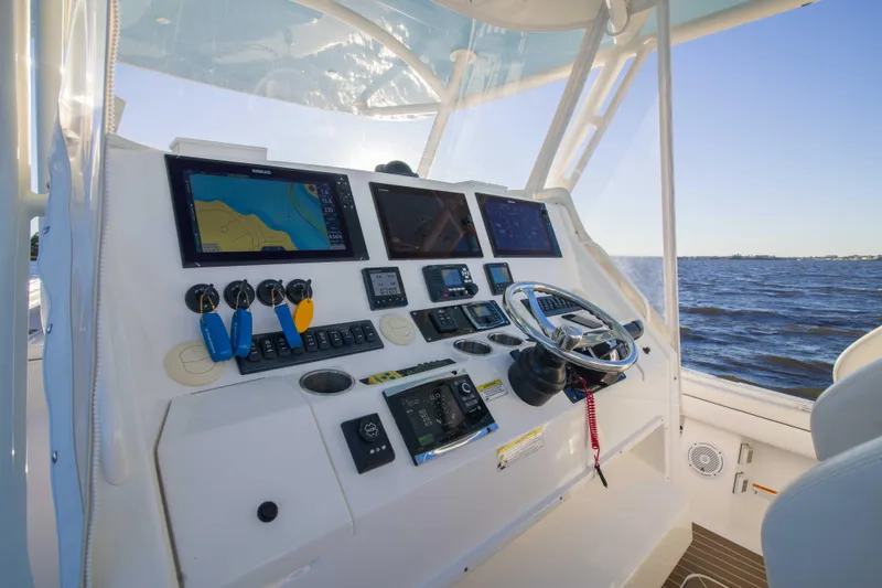 Slide: The Image of Control panel of 2016 Regulator 41 boat with navigation screens and steering wheel. - 2