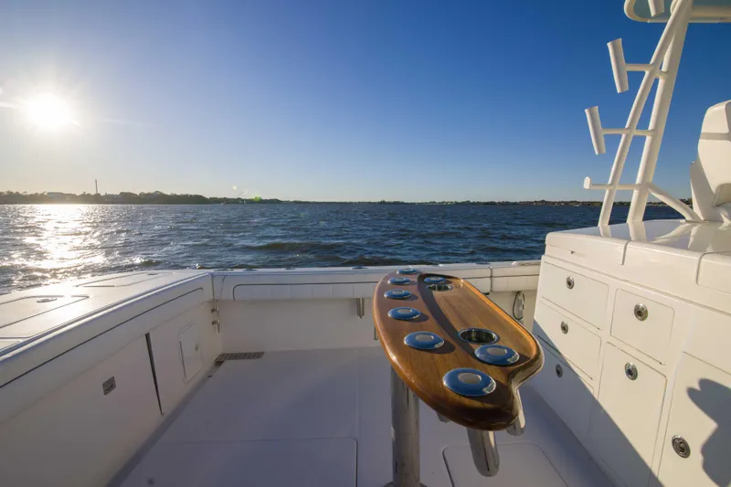 Slide: The Image of 2016 Regulator 41 boat deck with rod holders, ocean view, and sunny sky. - 21