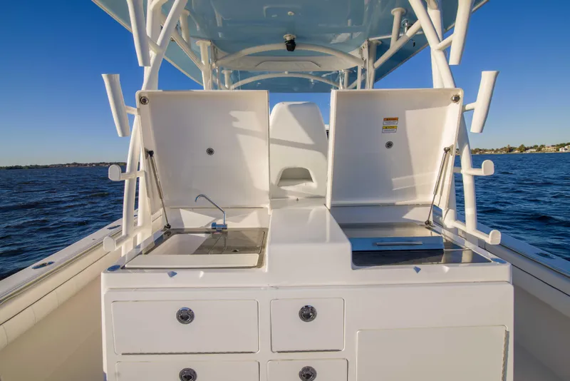 Slide: The Image of 2016 Regulator 41 boat with open storage compartments on deck, ocean background. - 24