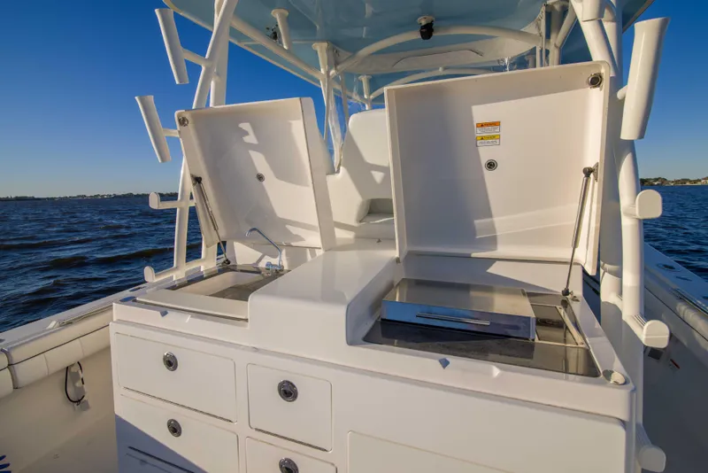 Slide: The Image of 2016 Regulator 41 boat with open storage compartments on deck, ocean view. - 25