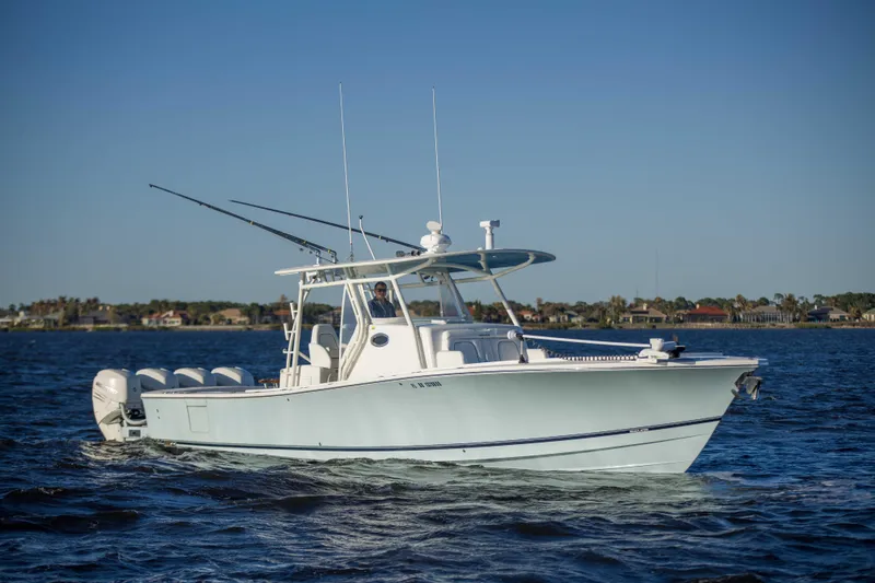 Slide: The Image of 2016 Regulator 41 boat cruising on open water under clear blue sky. - 28