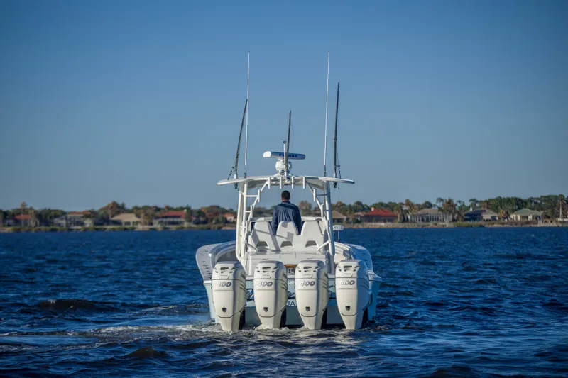 Slide: The Image of 2016 Regulator 41 boat cruising on open water with four engines. - 29