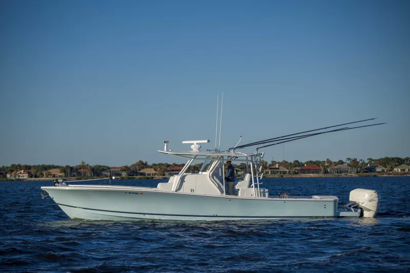 Slide: The Image of 2016 Regulator 41 boat cruising on calm waters under clear blue sky. - 32