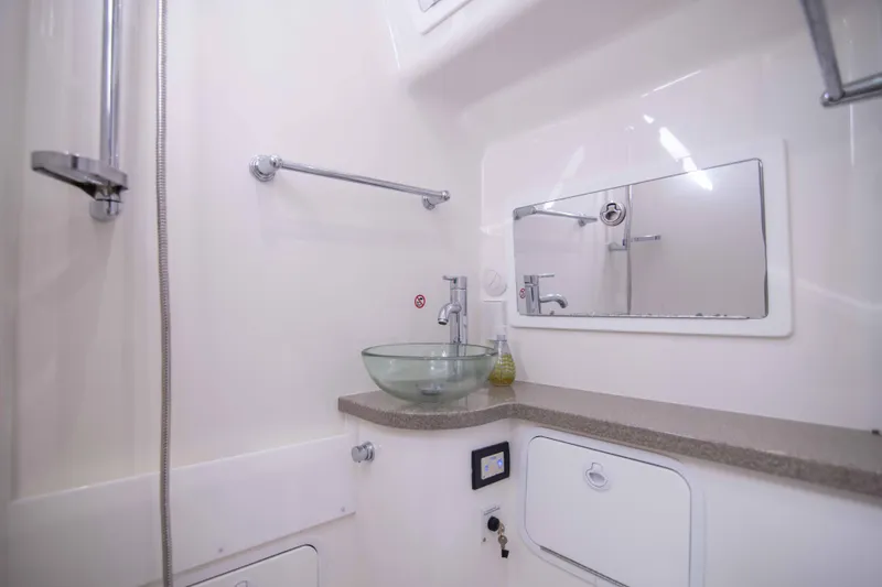 Slide: The Image of Luxurious bathroom interior of 2016 Regulator 41 boat with modern fixtures and glass sink. - 9