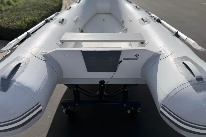 Slide: The Image of Inflatable Achilles HB-300FX boat, 2012 model, on a trailer in a sunny outdoor setting. - 10