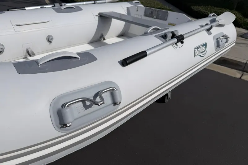 Slide: The Image of Inflatable Achilles HB-300FX boat, 2012 model, with oar and handles on deck. - 13