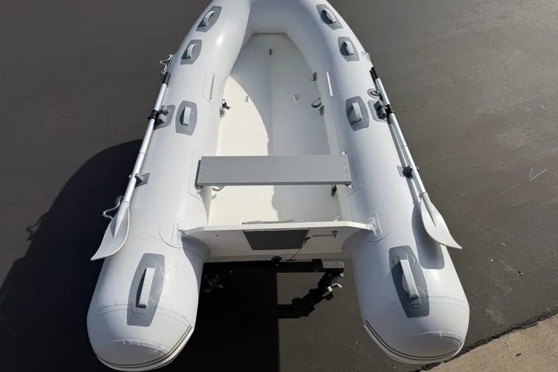Slide: The Image of Inflatable Achilles HB-300FX boat, 2012 model, on a concrete surface. - 6