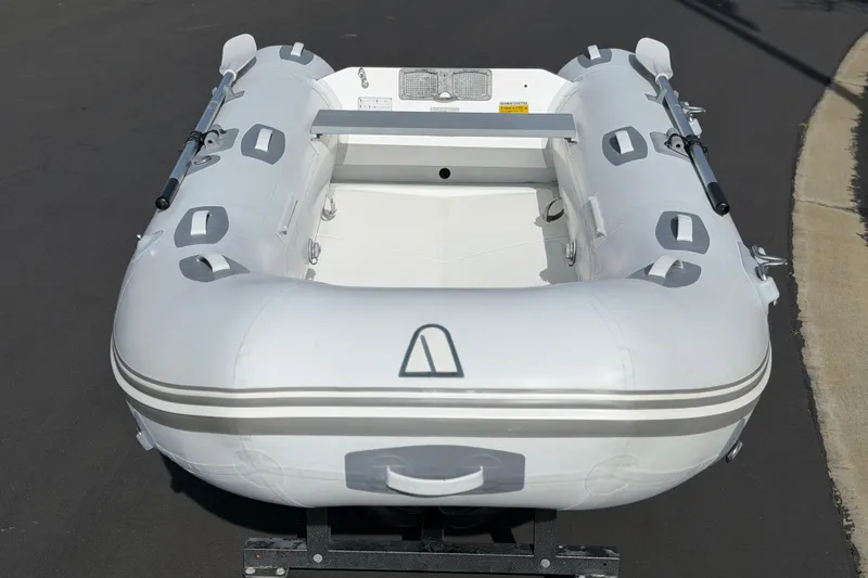 Slide: The Image of Inflatable Achilles HB-300FX boat, 2012 model, on pavement, viewed from the front. - 8