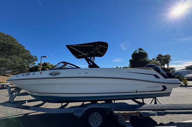 The Image of 2022 Bayliner VR6 Bowrider OB on trailer under clear blue sky. - 0