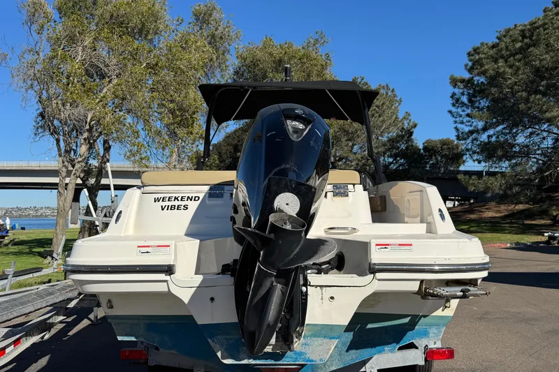 Slide: The Image of 2022 Bayliner VR6 Bowrider OB boat with "Weekend Vibes" text, parked near a scenic lake. - 10